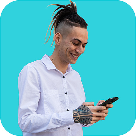Young man smiling while using his phone on a bright blue background, promoting Lending Room's fast online loan application.