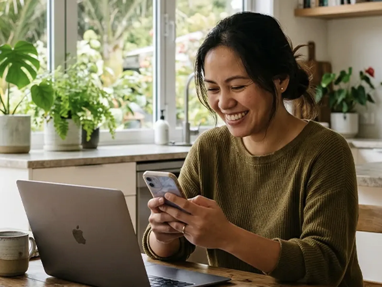 Work visa holder checking loan options on a phone at home in NZ with Lending Room